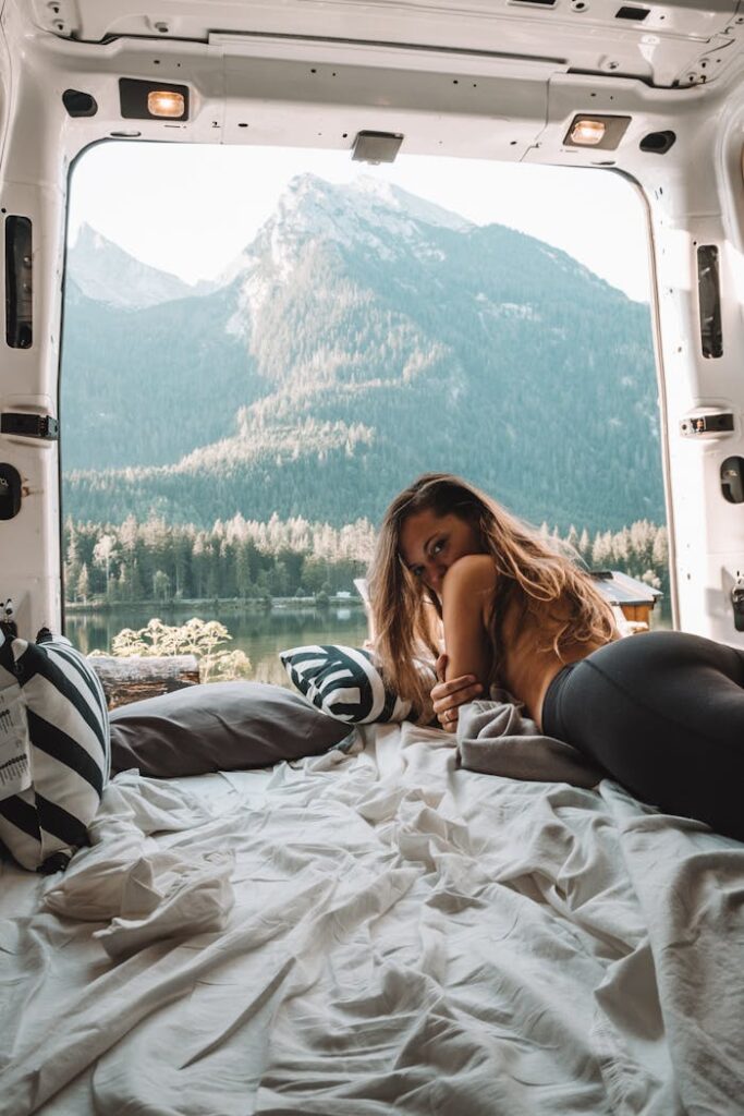 Relaxing in a campervan with a stunning mountain view, embodying the essence of van life.