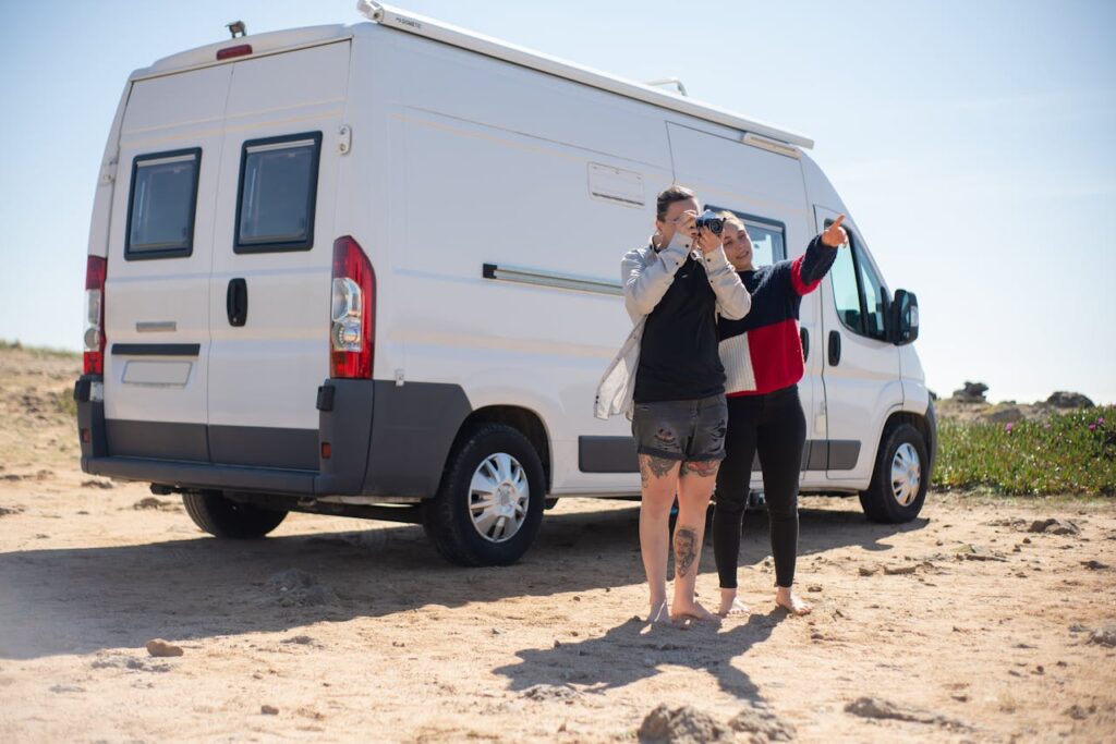 A couple enjoys a summer road trip in a campervan on the scenic Portuguese coastline.